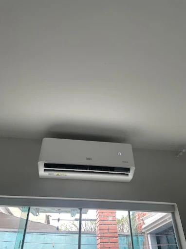 Ar-condicionado split instalado acima de uma porta de vidro